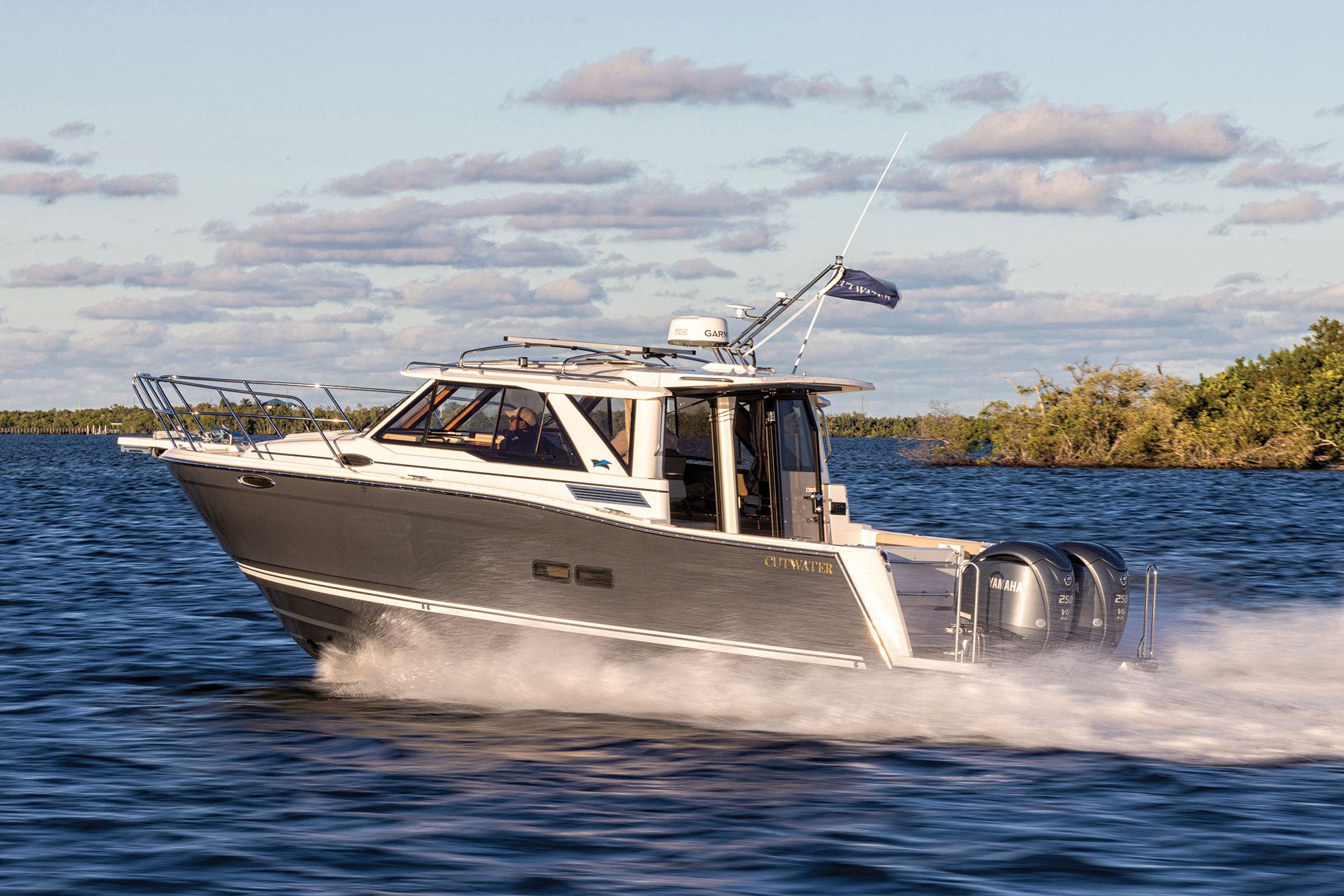 Cutwater C-288 Coupe running near shore