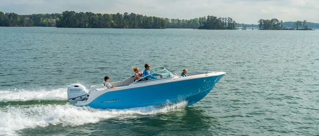 The Sailfish 226DC cutting across water with a family onboard